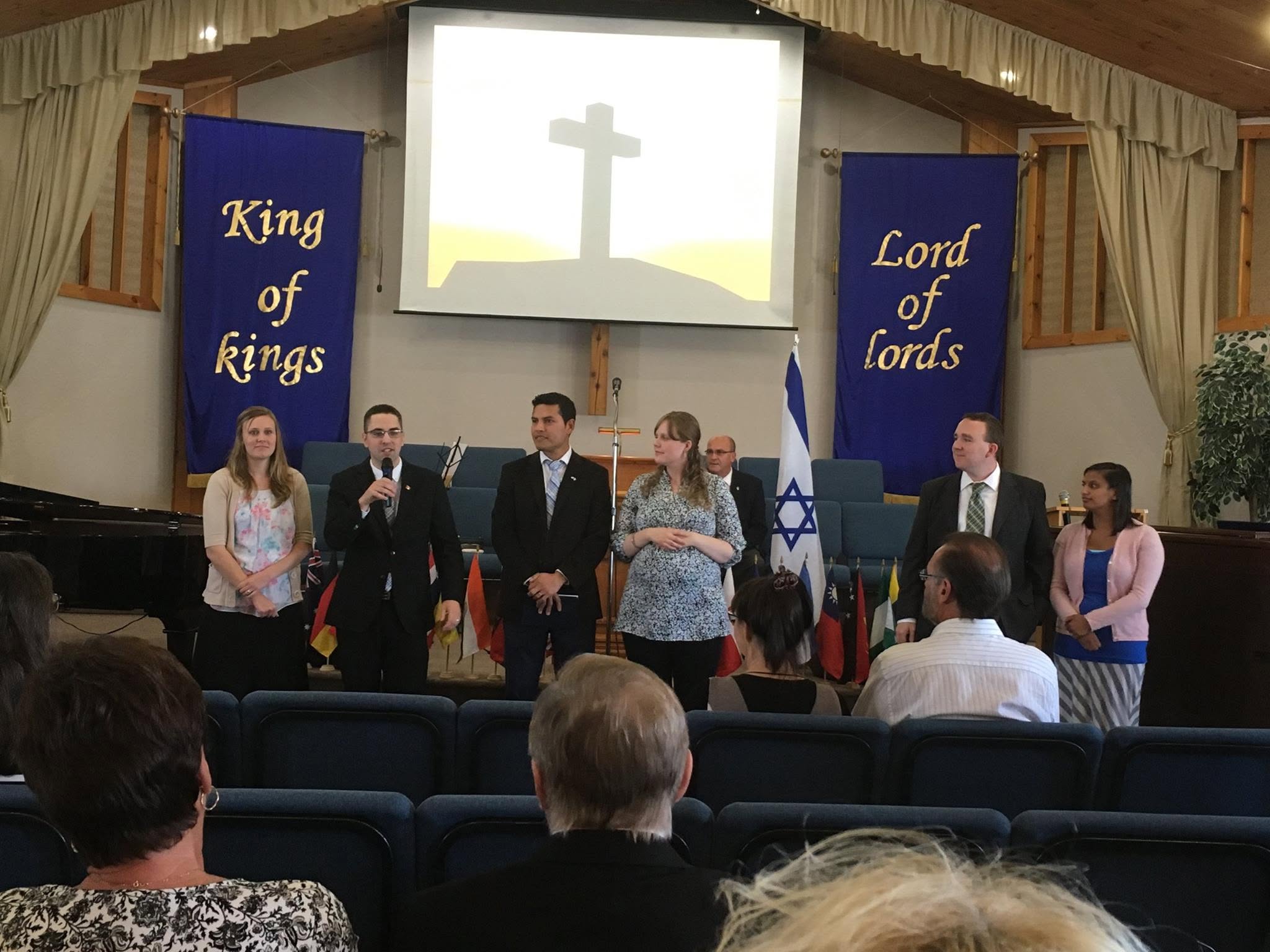 A group taking part in a service at the front of the church.